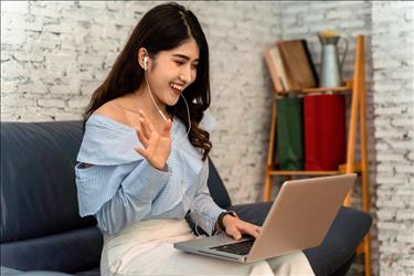 Woman meeting her team virtually for her new remote marketing job