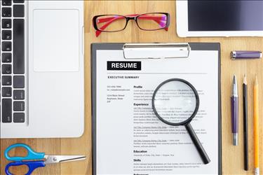 resume on a desk with various office supplies around it