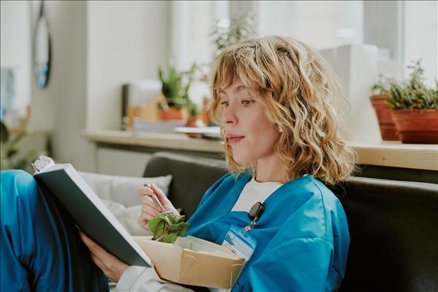 nurse eating a salad in the breakroom