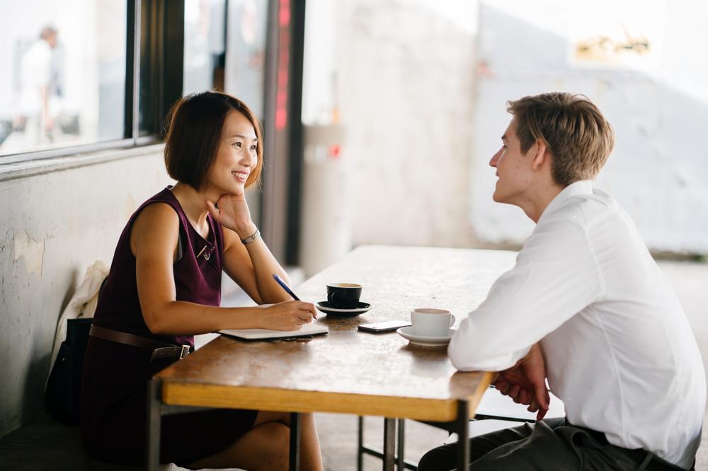 job seeker and employer having an interview at a coffee shop