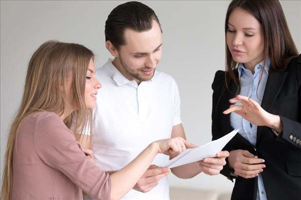 personal banker going over paperwork with her clients