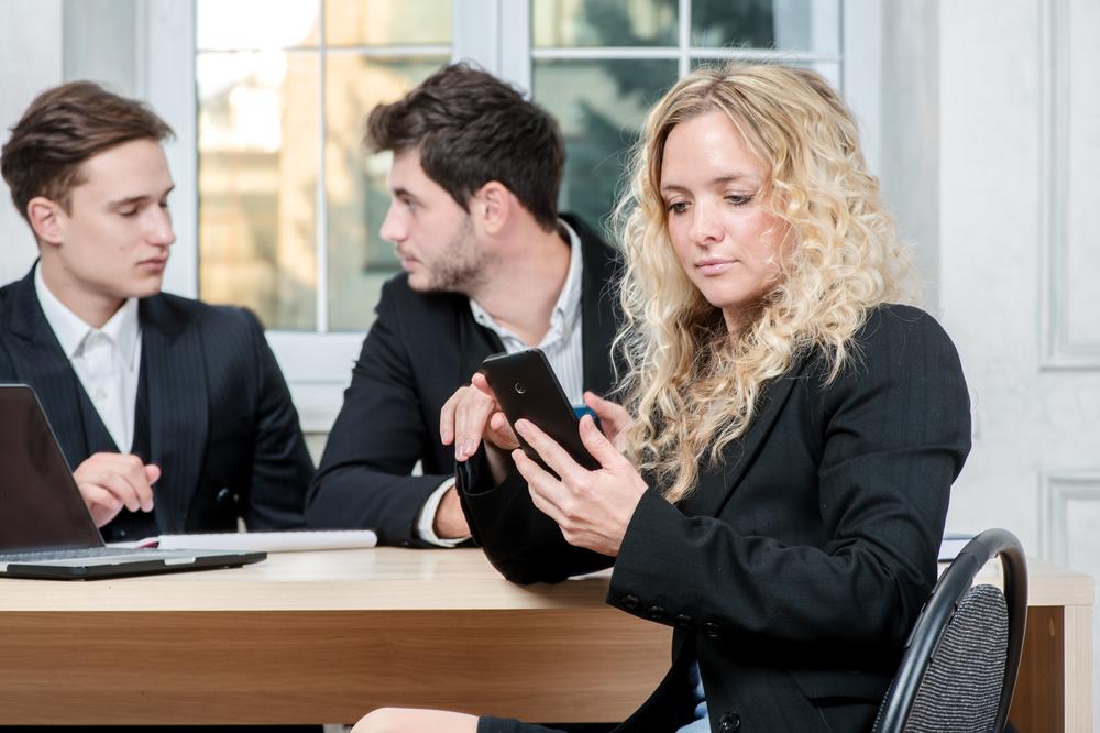 interviewee checking her cell phone in the middle of an interview