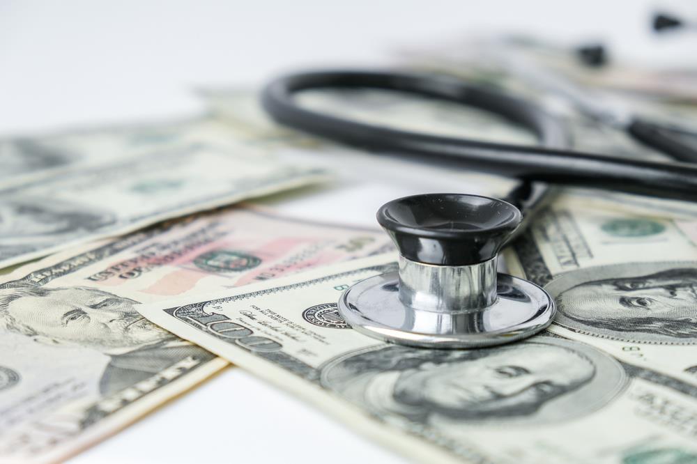 Stethoscope on pile of money