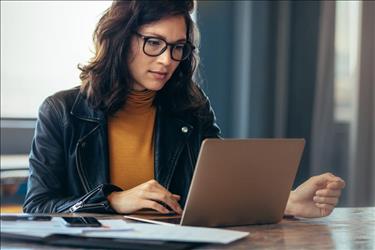 Woman working on cover letter on latop