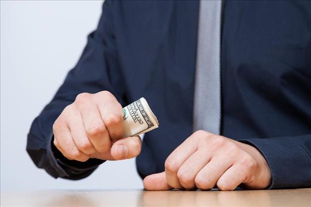 Businessman Squeezing Money