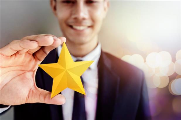 employee holding up a gold star