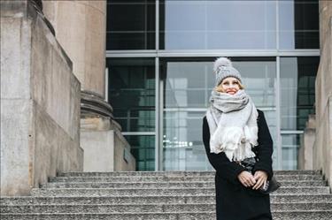 Young woman wearing stocking cap and heavy scarf for winter job interview