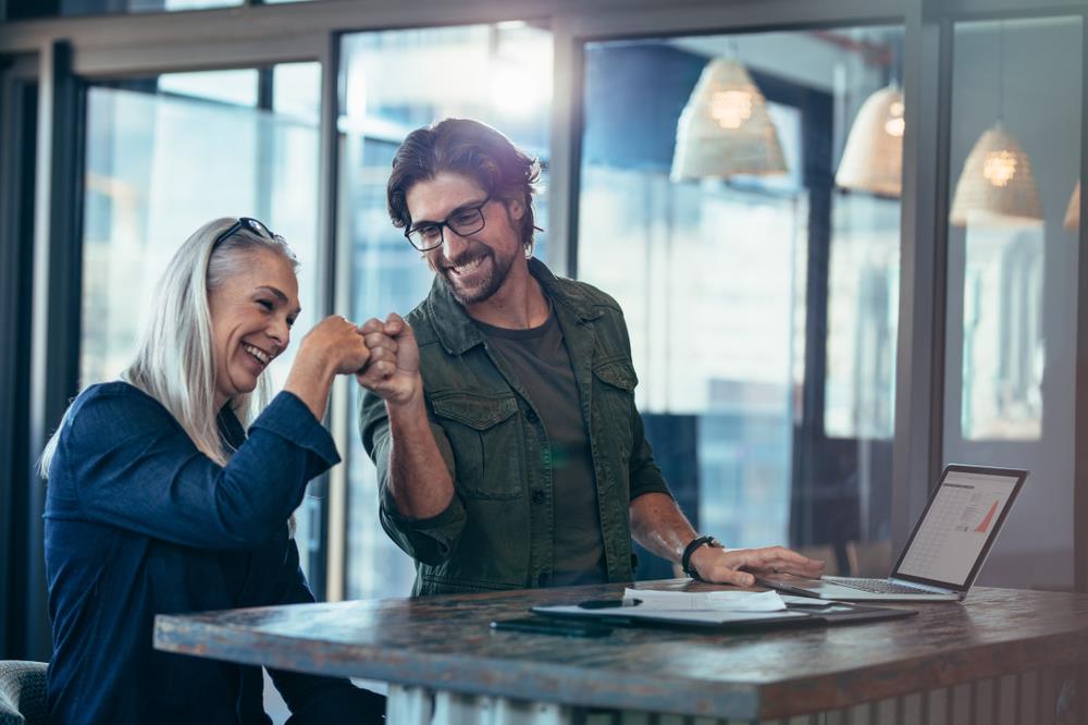 happy employees giving each other a fist bump