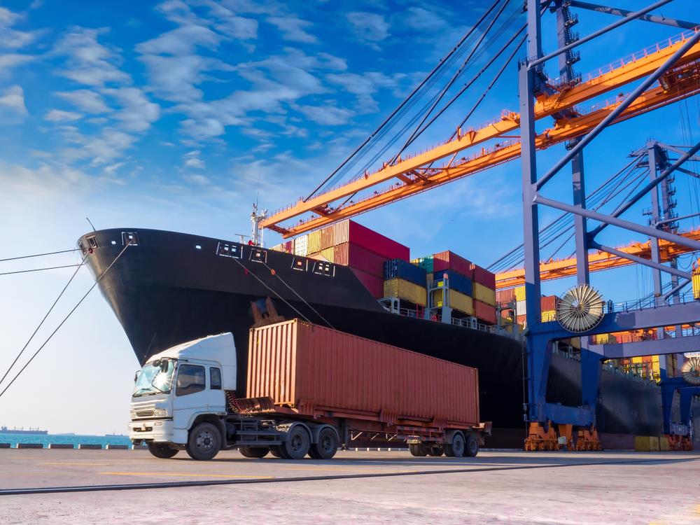 truck in front of a ship at a loading dock