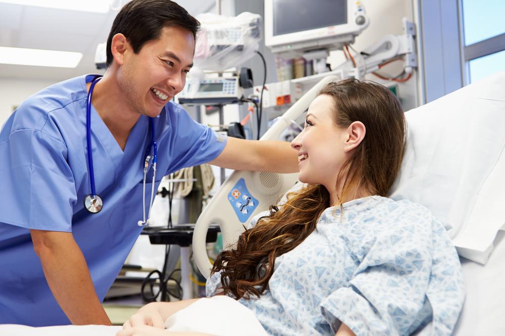 nurse assisting a patient in the emergency room