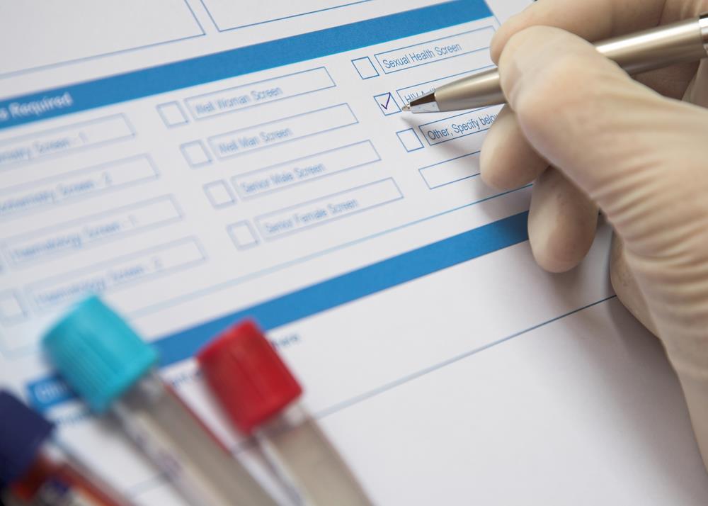 phlebotomist updating a patient's chart