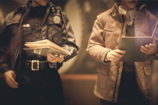 Police officer and law enforcement colleague reviewing files