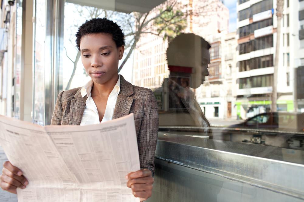 finance professional reading the finance section of the newspaper