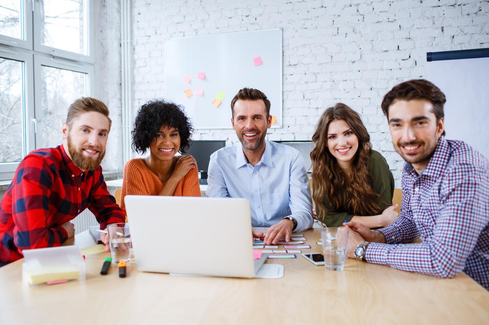 Group of happy employees at a meeting table