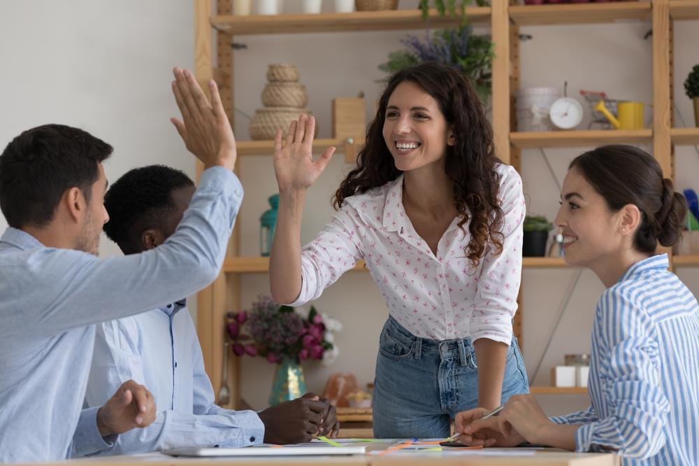 employees celebrating and giving high-fives