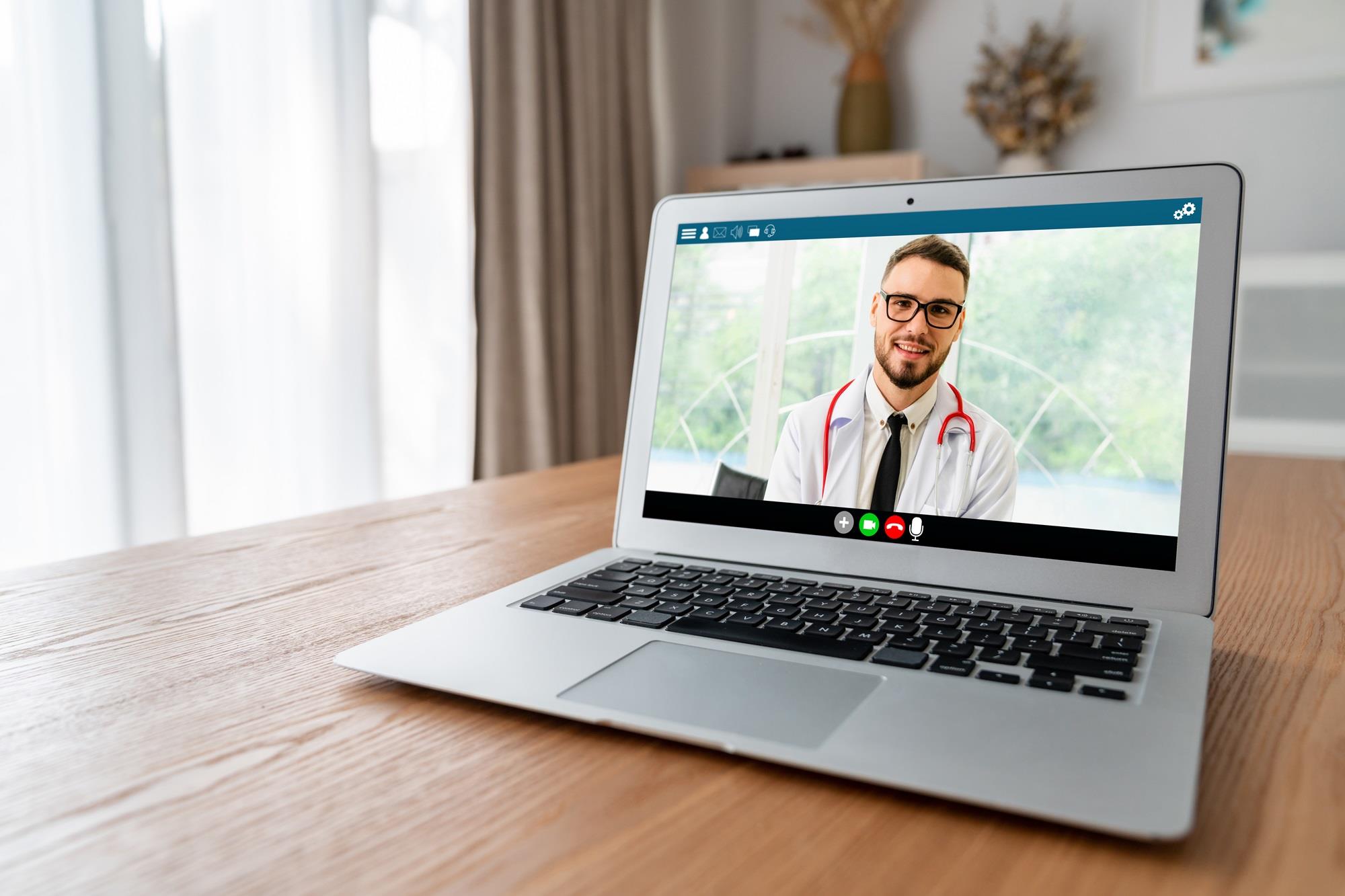 telehealth provider smiling on a laptop screen