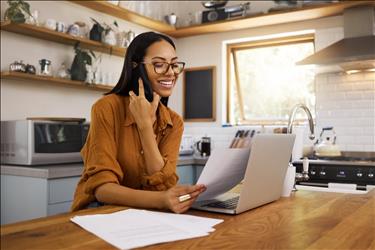 remote worker talking on the phone in her kitchen