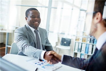 new hire shaking hands after interview with supervisor