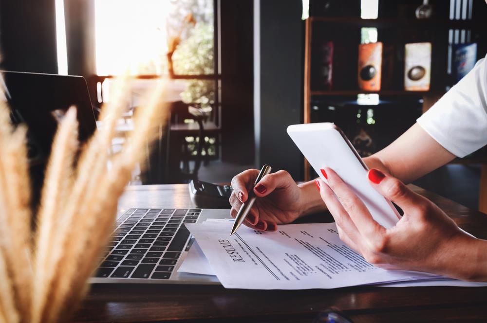 job seeker working on her resume before reaching out to companies about unlisted jobs