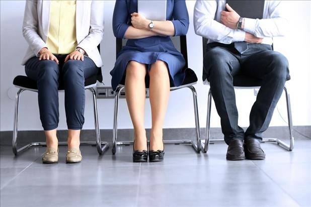 Candidates in professional attire waiting to interview