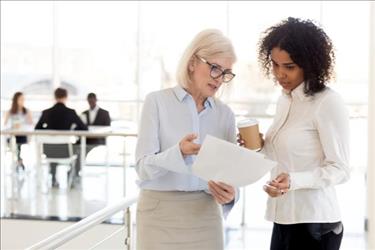 employees looking at paper