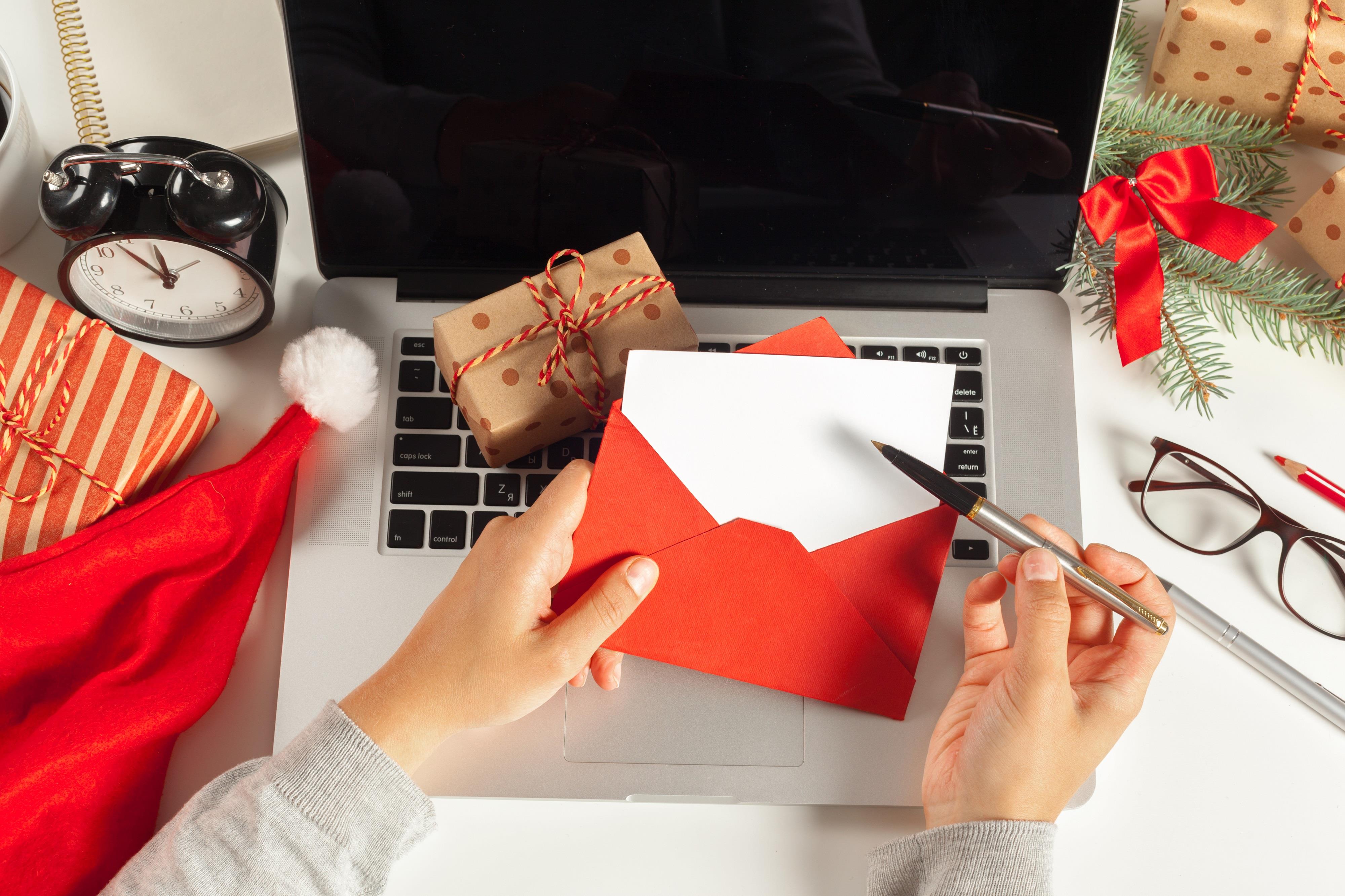 person writing a holiday card