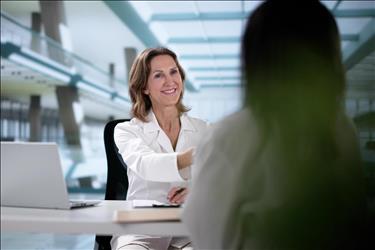 doctor shaking hands with an applicant during an interview