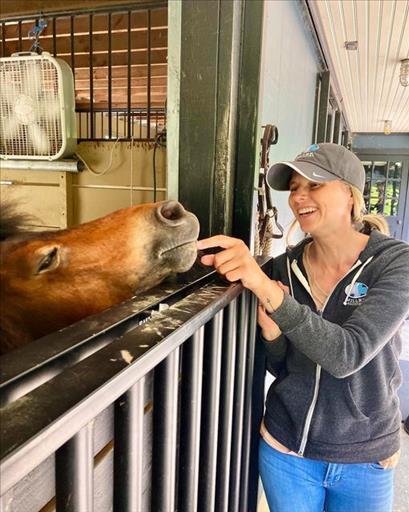 Woman feeding horse