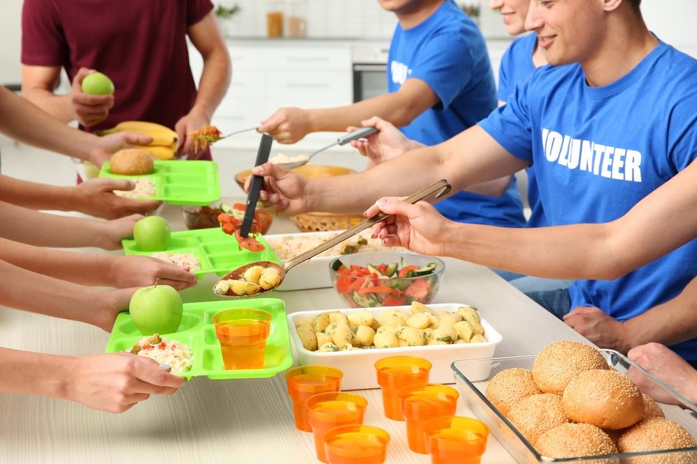 group of employees volunteering together serving lunch