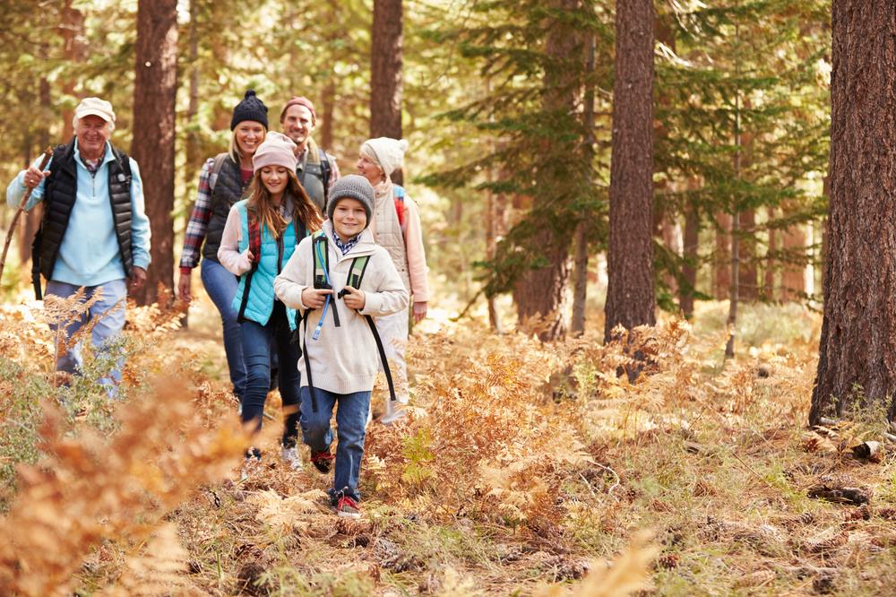 family using their staycation time to hike on a local trail