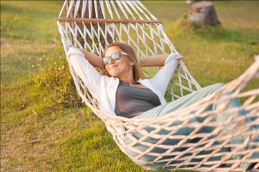 woman relaxing in her hammock while taking a staycation at home