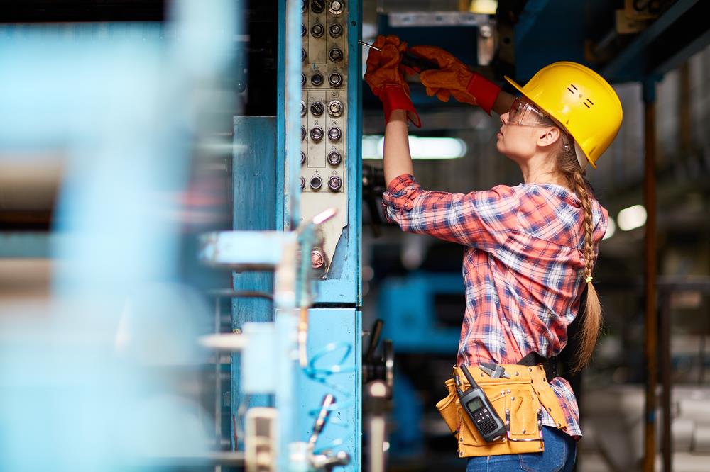 female maintenance technician working on equipment