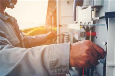 close up photo of maintenance technician working on solar power equipment