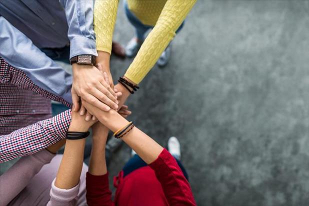 Employees putting their hands together