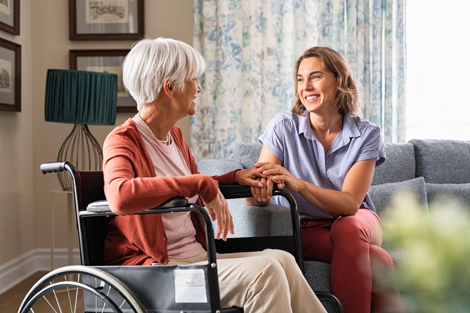 daughter with her elderly mother in a wheelchair