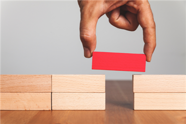 hand using a block to create a bridge