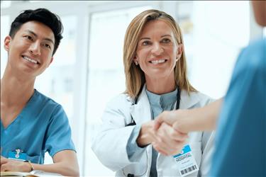 smiling doctor shaking hands with a potential hire