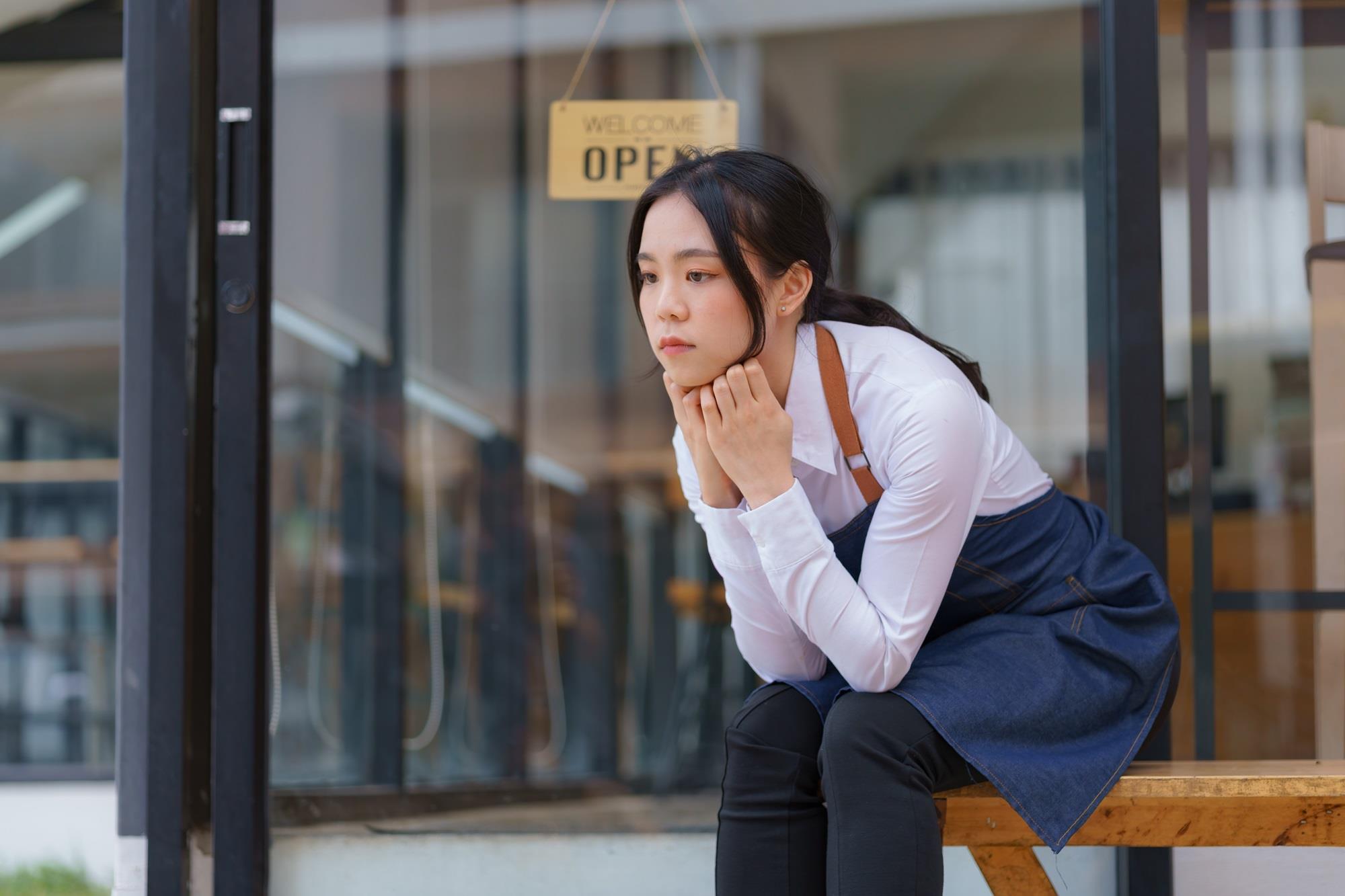 overworked restaurant employee sitting outside