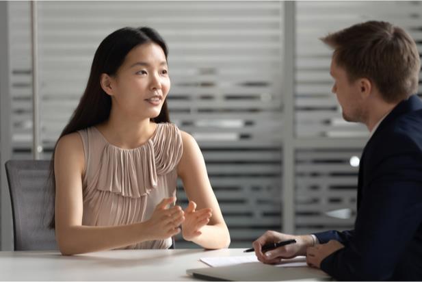 employees talking at a desk