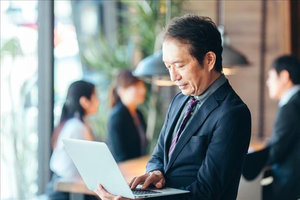 Older adult man looking for careers on laptop