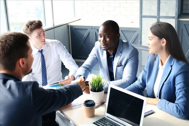 Interview shaking hands with candidates during group interview