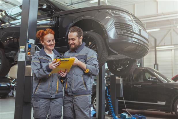 two automotive technicians working together in their shop