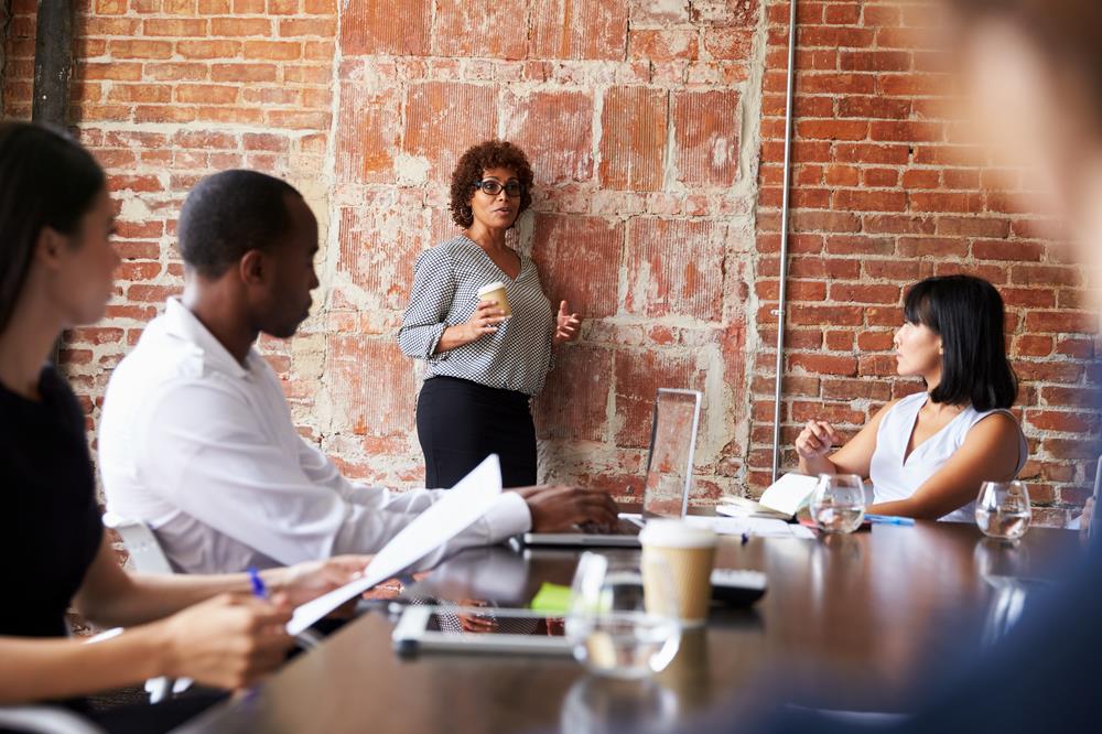 businesswoman leading a meeting at her office