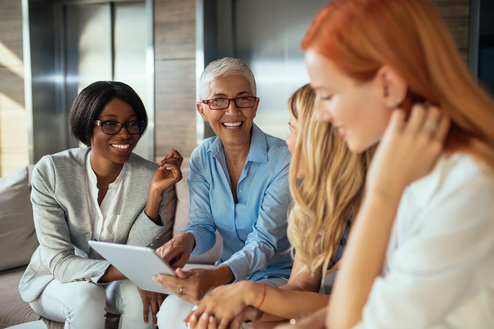 diverse group of women colleagues meeting together