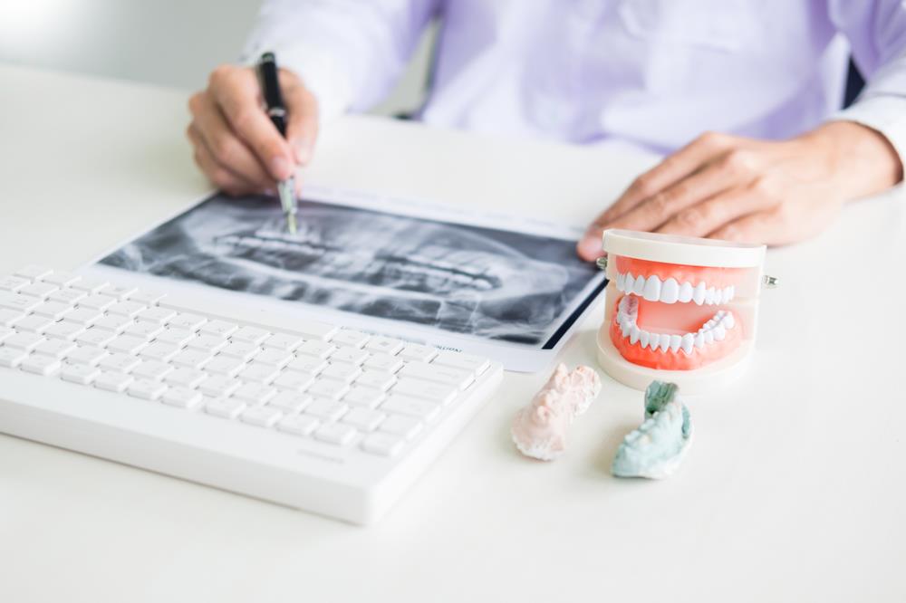 Forensic dentist reviewing dental records