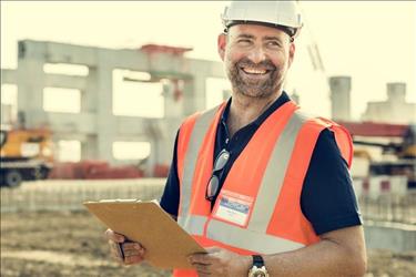 construction worker looking at clipboard