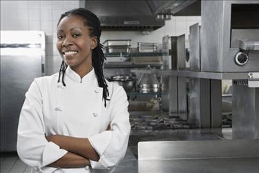 Chef posing in an empty kitchen