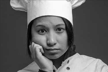 Upset chef thinking of how to respond to questions about being fired or laid off