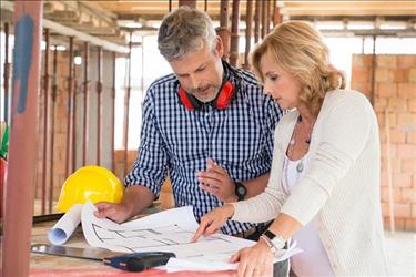 Construction superintendent going over plans with a customer