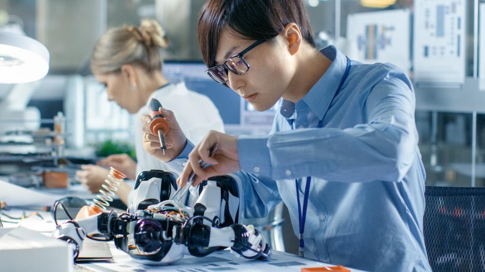 two robotics engineers working at their desks